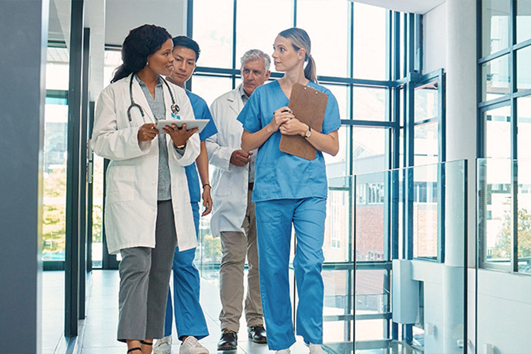 Healthcare leaders, providers and business professionals collaborating in a modern hospital setting 