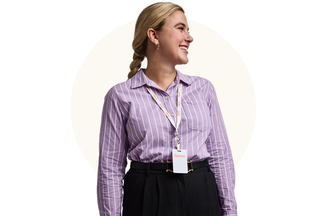 Professional standing and wearing an Optum badge against a neutral background 