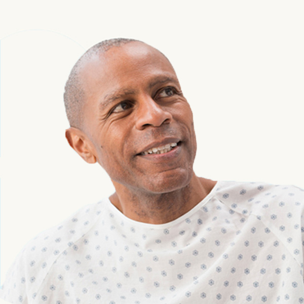 A male patient wearing a hospital gown.